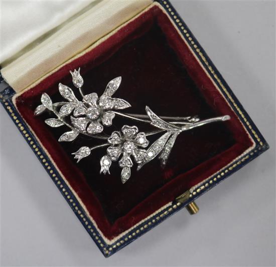 A 1960s 18ct white gold and diamond set floral spray brooch, 51mm.